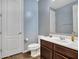 Well-lit bathroom with a modern vanity, toilet, and tiled flooring at 18225 W Mackenzie Dr, Goodyear, AZ 85395