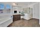 Bright bathroom featuring a soaking tub, glass shower, and vanity with ample counter space at 18225 W Mackenzie Dr, Goodyear, AZ 85395