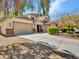 Two-story home with a large driveway and three-car garage, showcasing its well-maintained landscaping and exterior design at 18225 W Mackenzie Dr, Goodyear, AZ 85395