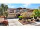 Two-story home with a landscaped front yard, covered entryway, and a two-car garage at 18225 W Mackenzie Dr, Goodyear, AZ 85395