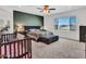 Spacious main bedroom with a large window, accent wall, and neutral colored carpet at 18225 W Mackenzie Dr, Goodyear, AZ 85395