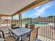 View of the outdoor covered patio overlooking the backyard pool with a safety fence at 18225 W Mackenzie Dr, Goodyear, AZ 85395