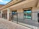 View of the covered patio with a black wrought iron safety fence around the outdoor space at 18225 W Mackenzie Dr, Goodyear, AZ 85395