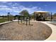 Community playground with swings, picnic area, and covered play area at 18225 W Mackenzie Dr, Goodyear, AZ 85395