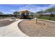 Community playground featuring a large shaded play structure and seating areas at 18225 W Mackenzie Dr, Goodyear, AZ 85395