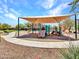 Community playground with a large shaded play structure and walking path at 18225 W Mackenzie Dr, Goodyear, AZ 85395