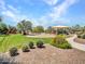 Community playground with a play structure, swings, and green space with seating at 18225 W Mackenzie Dr, Goodyear, AZ 85395