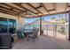 Relaxing covered patio with dining set overlooking pool area and palm trees at 1830 N 87Th Ter, Scottsdale, AZ 85257