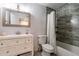 This bathroom features a shower-tub combo, light gray paint, a mosaic mirror, and a white vanity at 1830 N 87Th Ter, Scottsdale, AZ 85257