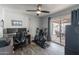 Bedroom with wood-look floors, exercise bike, ceiling fan and sliding glass door to the patio at 1830 N 87Th Ter, Scottsdale, AZ 85257