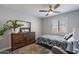 A bedroom with a ceiling fan, plush carpet, and wooden dresser at 1830 N 87Th Ter, Scottsdale, AZ 85257