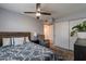 A cozy bedroom with a ceiling fan, carpet, and a closet at 1830 N 87Th Ter, Scottsdale, AZ 85257