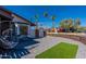 A single-story home with a modern fence, desert landscaping, and a cozy outdoor sitting area at 1830 N 87Th Ter, Scottsdale, AZ 85257