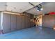 The garage contains blue floors and black storage cabinets, and contains a refrigerator and lighting at 1830 N 87Th Ter, Scottsdale, AZ 85257