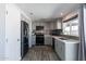 Modern kitchen featuring gray cabinets, stainless steel appliances, and stylish backsplash at 1830 N 87Th Ter, Scottsdale, AZ 85257