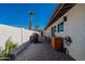 Outdoor patio area with block walls, brick pavers, and a grilling area under clear blue skies at 1830 N 87Th Ter, Scottsdale, AZ 85257