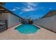 This backyard features a fenced-in pool, and a concrete patio, surrounded by palm trees at 1830 N 87Th Ter, Scottsdale, AZ 85257