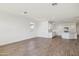 Open-concept living room with wood-look flooring flowing into the kitchen and featuring abundant light at 18848 E Bruno Dr, Gold Canyon, AZ 85118