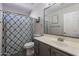 Bathroom features a gray vanity, a large mirror, and a shower/tub combination with a patterned curtain at 1896 S Porter St, Gilbert, AZ 85295