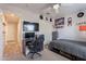 Well-lit bedroom featuring a gaming setup, ceiling fan, a closet, and coordinated decor accents at 1896 S Porter St, Gilbert, AZ 85295