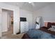 Bedroom featuring a dresser with a TV, a full-length mirror, and an adjacent doorway at 1896 S Porter St, Gilbert, AZ 85295