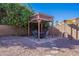 Backyard gazebo featuring a table and chairs, providing a relaxing outdoor space for dining and lounging at 1896 S Porter St, Gilbert, AZ 85295