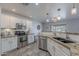 A well-lit kitchen featuring stainless steel appliances, granite counters, and tile backsplash at 1896 S Porter St, Gilbert, AZ 85295