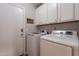 Convenient laundry room with white cabinets above a modern washer and dryer set at 1896 S Porter St, Gilbert, AZ 85295