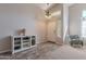 Bright living room featuring wood-look tile, carpet, chandelier, and a storage cabinet at 1896 S Porter St, Gilbert, AZ 85295