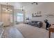 Bright living room featuring high ceilings, ceiling fans, large windows, and a gray sofa at 1896 S Porter St, Gilbert, AZ 85295