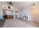 Bright living room featuring high ceilings, ceiling fans, large windows, and a gray sofa at 1896 S Porter St, Gilbert, AZ 85295