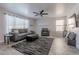 Comfortable living room featuring a ceiling fan, and neutral-colored walls and flooring at 1896 S Porter St, Gilbert, AZ 85295