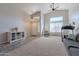 Bright living room featuring high ceilings, ceiling fans, large windows, and a gray sofa at 1896 S Porter St, Gilbert, AZ 85295