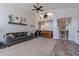 Bright living room featuring high ceilings, ceiling fans, large windows, and a gray sofa at 1896 S Porter St, Gilbert, AZ 85295