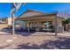 Backyard view featuring a covered patio, comfortable seating, and a glimpse of the inviting pool area at 1896 S Porter St, Gilbert, AZ 85295