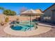 Backyard swimming pool with a unique kidney shape, surrounded by desert landscaping and lounge chairs at 1896 S Porter St, Gilbert, AZ 85295