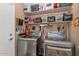 Well-organized laundry room with modern appliances and ample shelving space at 1918 E Williams Dr, Phoenix, AZ 85024