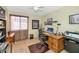 Functional home office with a desk, chair, natural light, and ample storage at 1918 E Williams Dr, Phoenix, AZ 85024