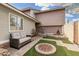 Landscaped backyard featuring artificial turf, a water feature, brick pavers, a stone firepit and cushioned outdoor seating at 1938 N 67Th St, Mesa, AZ 85205