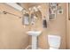 The bathroom features a pedestal sink, toilet, large oval mirror, and neutral walls at 1938 N 67Th St, Mesa, AZ 85205