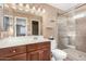 A full bathroom features a glass shower, tile floors, and a vanity with a sink and dark-stained cabinets at 1938 N 67Th St, Mesa, AZ 85205