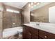 Bathroom featuring a vanity with sink, mirror, and tiled shower-tub combination at 1938 N 67Th St, Mesa, AZ 85205