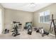 Neutral bedroom featuring workout equipment, natural light from a window, and a white ceiling fan at 1938 N 67Th St, Mesa, AZ 85205