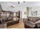 Open concept living room flowing into dining area with hardwood floors and leather furniture at 1938 N 67Th St, Mesa, AZ 85205