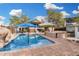 Lush backyard with a sparkling swimming pool, a hot tub, and a comfortable lounge area at 1938 N 67Th St, Mesa, AZ 85205