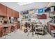 Workshop area with organized tools, workbenches, cabinets, and ample lighting for projects at 1938 N 67Th St, Mesa, AZ 85205