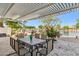 Scenic backyard patio with a view of the water, complete with outdoor seating and a pergola at 19927 N 108Th Ln, Sun City, AZ 85373