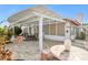 A backyard with a covered patio and an outdoor table and chairs; mosaic table in the foreground at 19927 N 108Th Ln, Sun City, AZ 85373