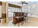 Inviting bar area featuring custom woodwork, seating, and ample natural light from large windows at 19927 N 108Th Ln, Sun City, AZ 85373