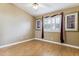 Bedroom with light walls, light wood floors, a ceiling fan, and shuttered windows at 19927 N 108Th Ln, Sun City, AZ 85373